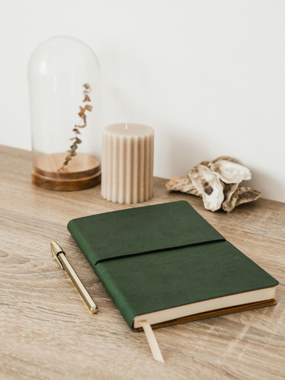 a green notebook sitting on top of a wooden table