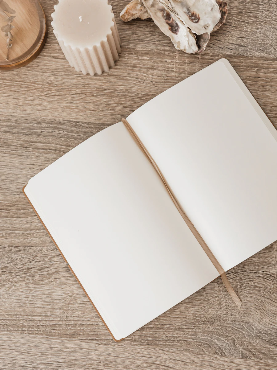 illume: From Shadow to Light — open journal and candle in warm morning light