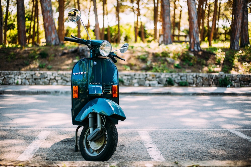 a blue scooter parked in a parking lot