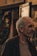 an older man standing in front of a store