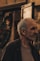 an older man standing in front of a store