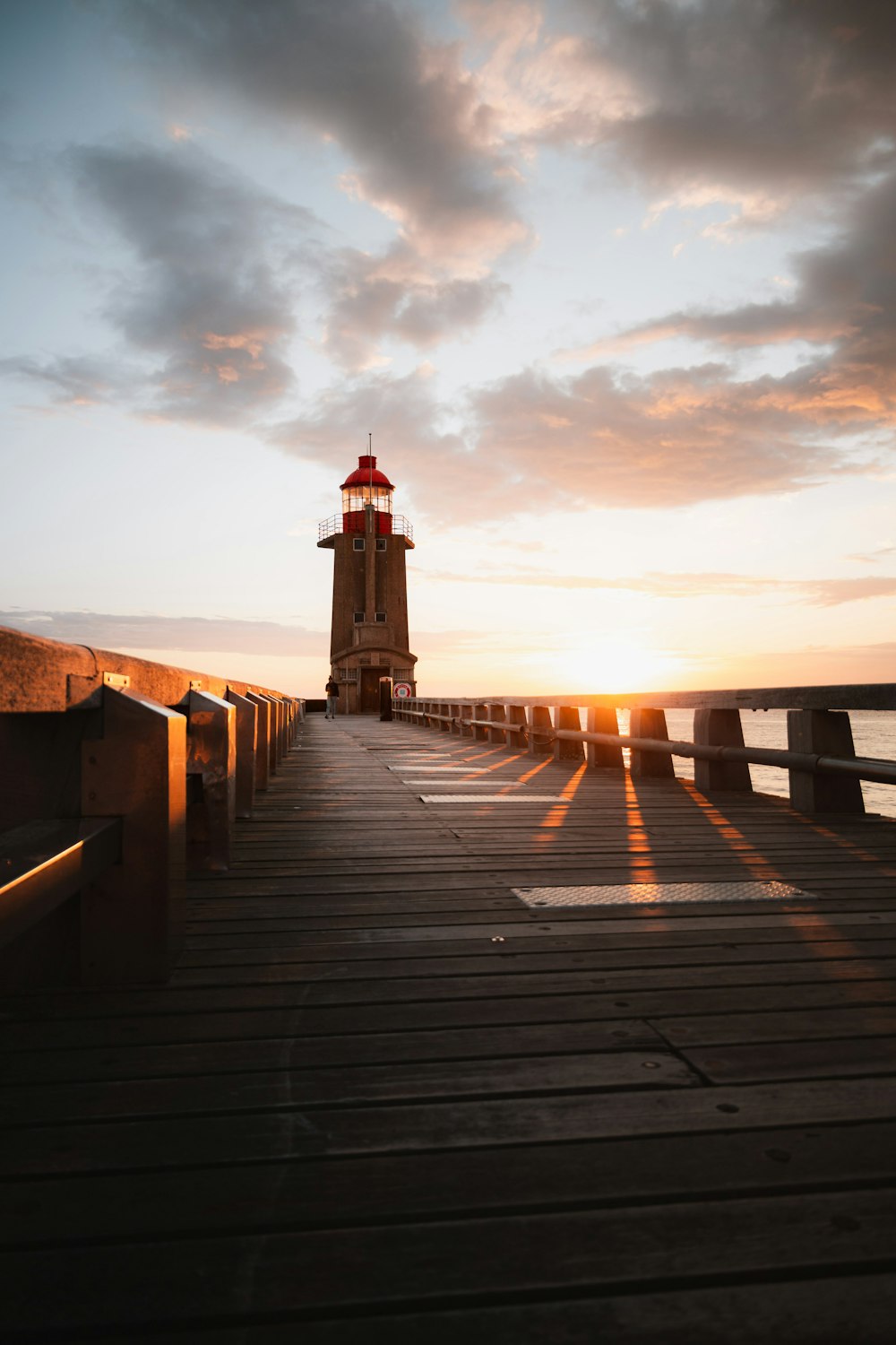 a light house sitting on top of a wooden pier