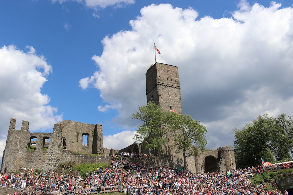 a large crowd of people in front of a castle