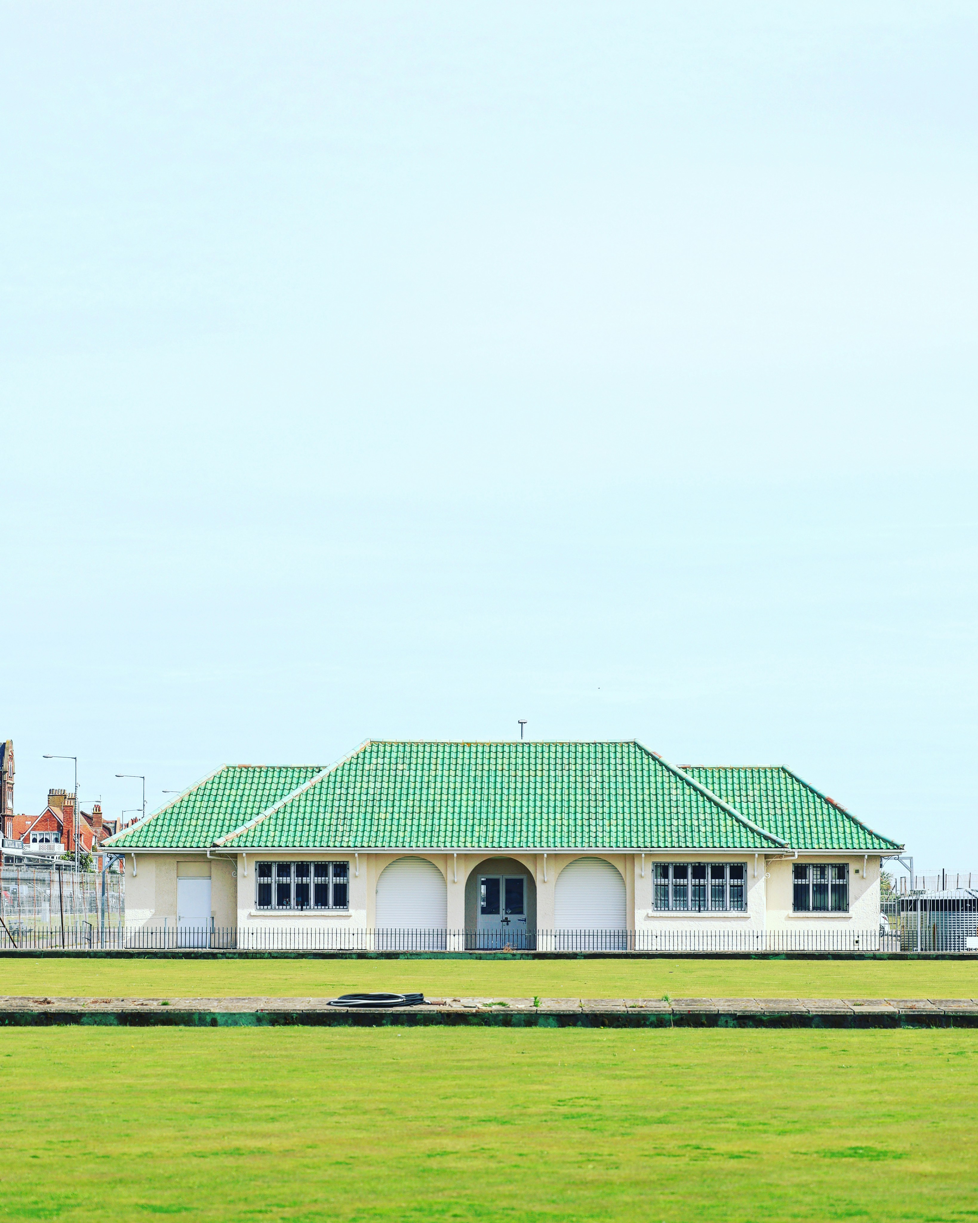 a large white building with a green roof