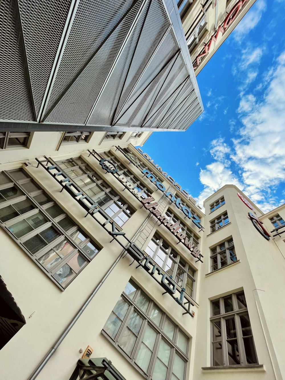 a tall white building with lots of windows