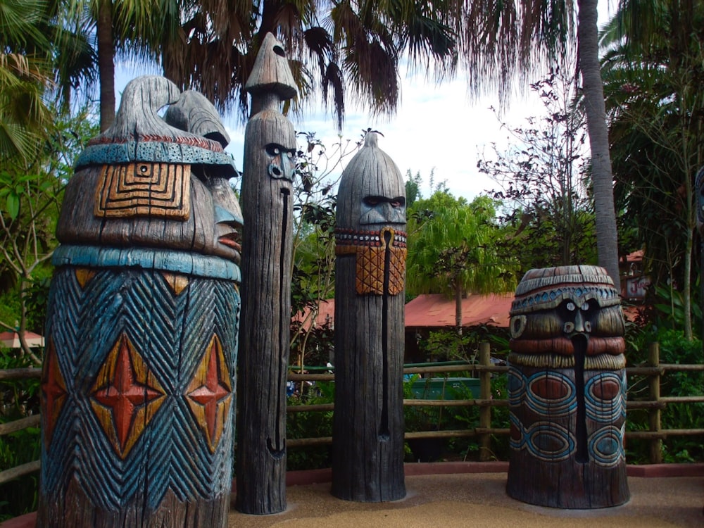 a group of wooden statues sitting next to each other