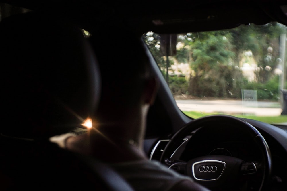 a man driving a car in the dark