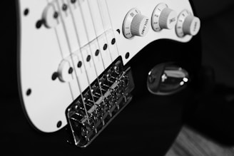 a close up of a white electric guitar
