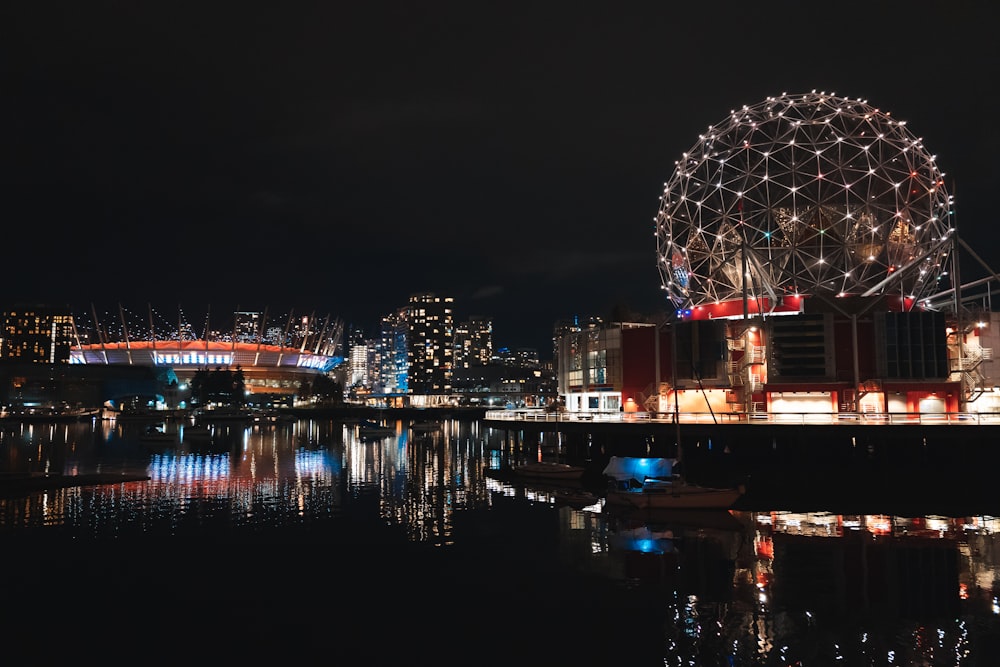 a night view of a city with a ferris wheel