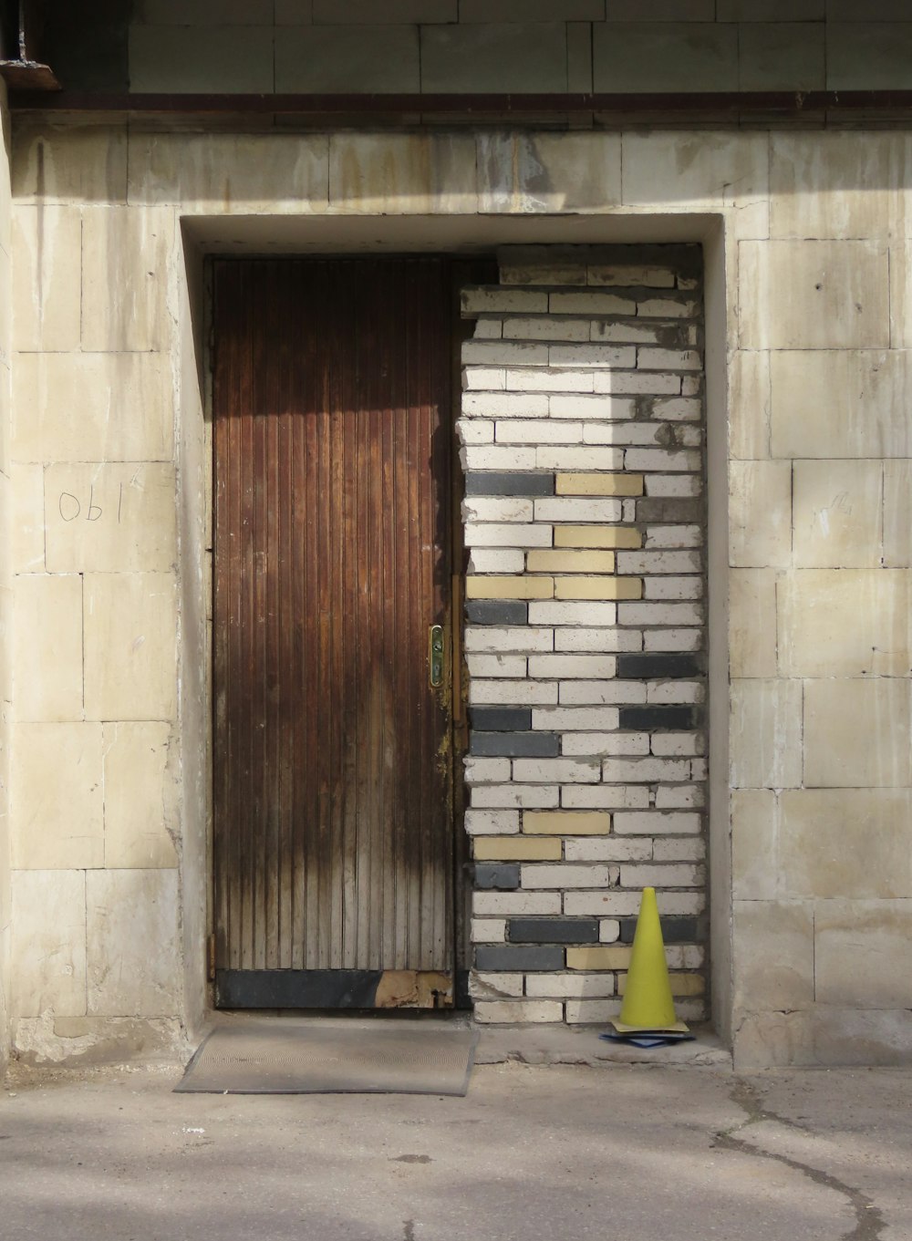 a yellow cone sitting in front of a door