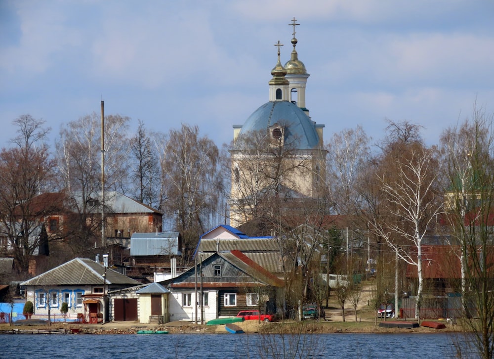 a church with a blue dome on top of a lake