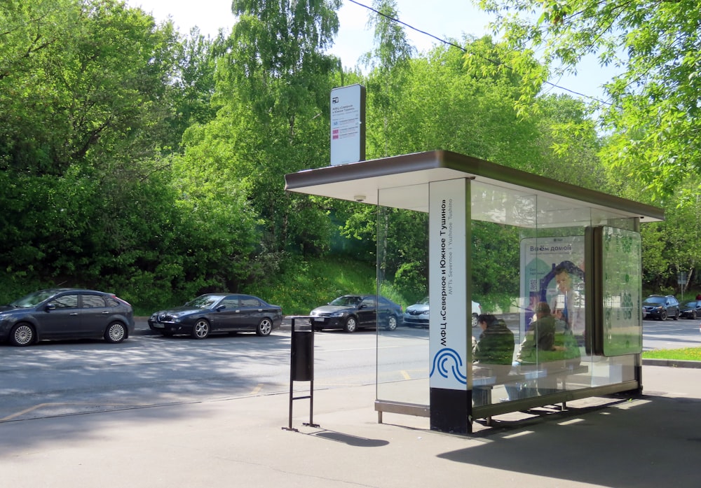 a bus stop with cars parked on the side of the road