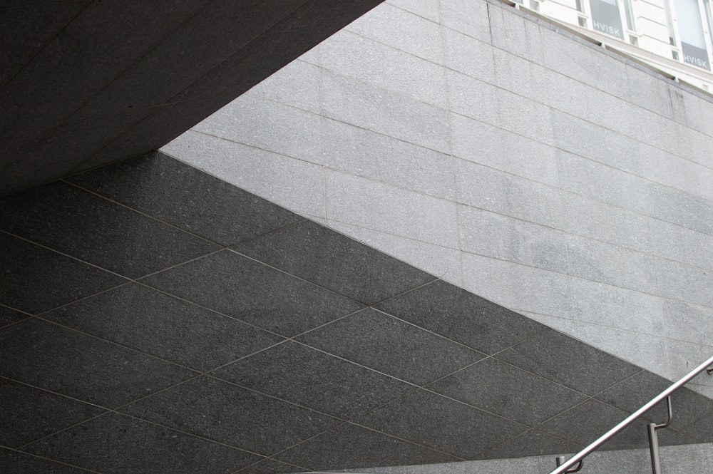 a man riding a skateboard down a metal hand rail