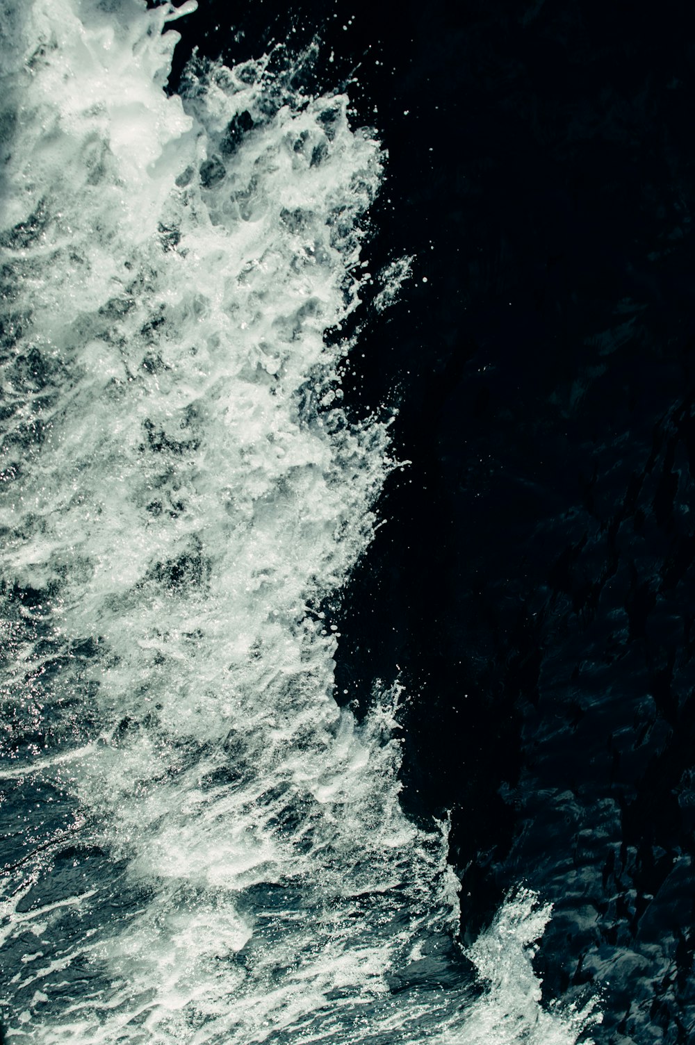 a man riding a surfboard on top of a wave in the ocean