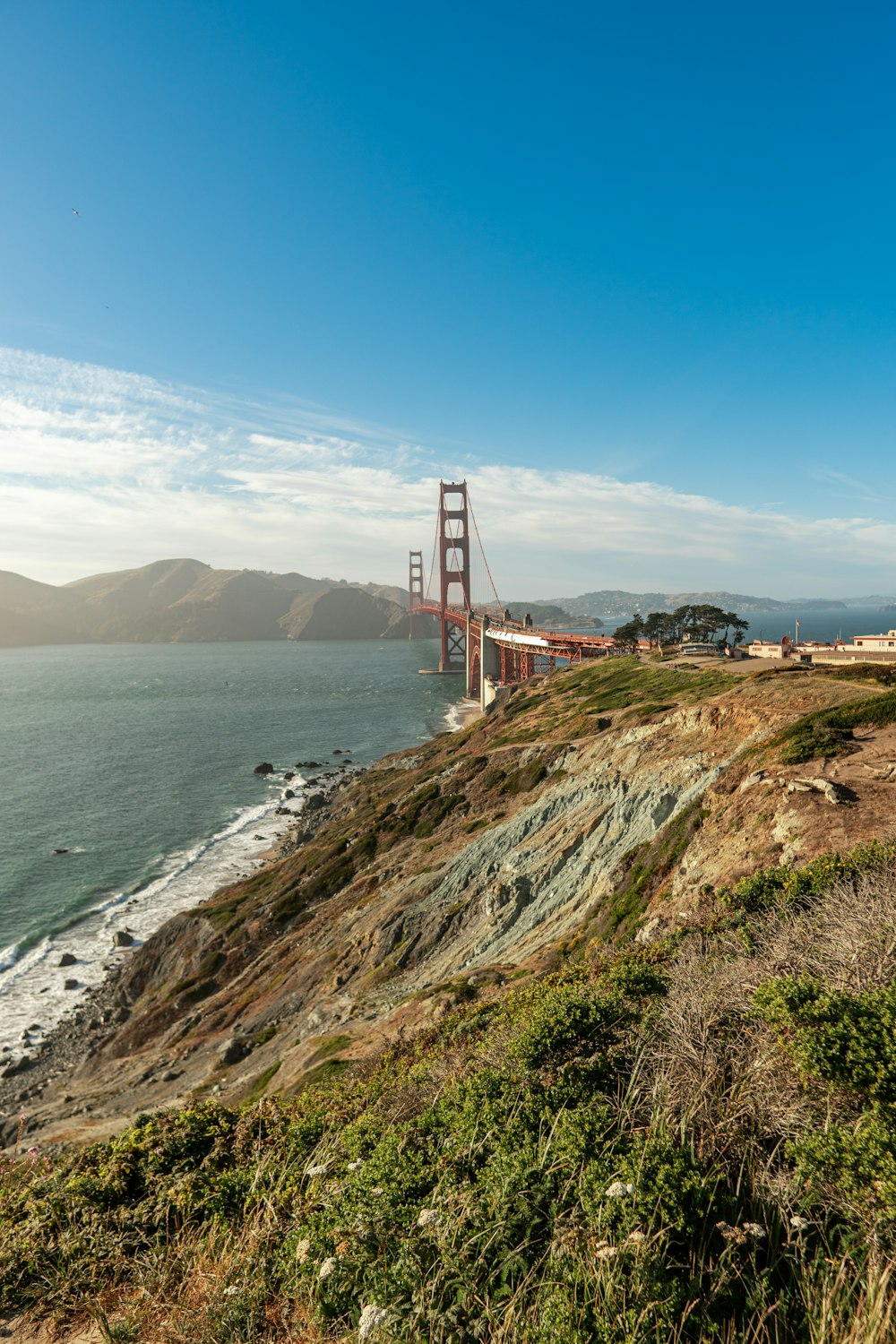a view of the golden gate bridge from the side of a hill