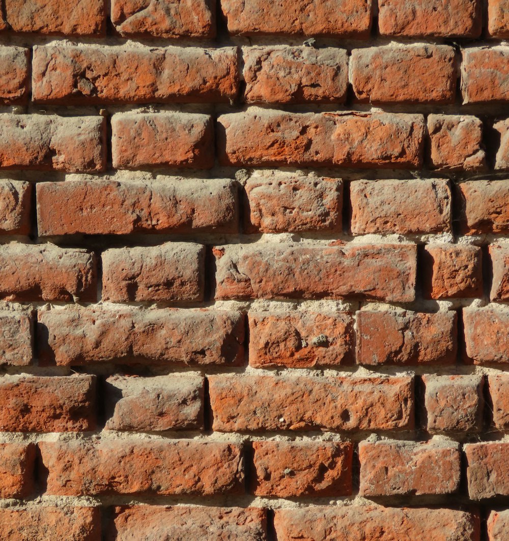 a close up of a brick wall made of red bricks