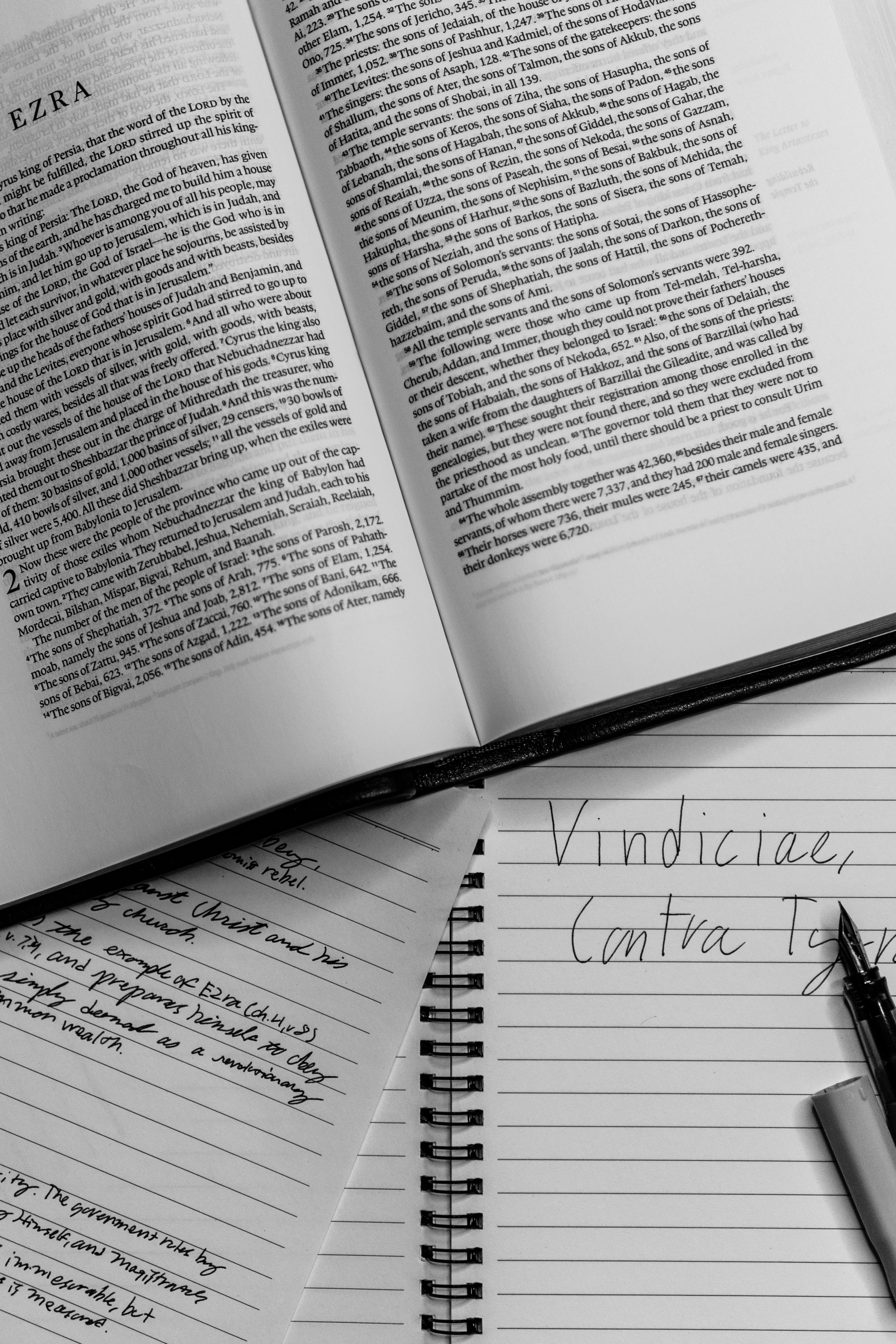 a pen sitting on top of an open book