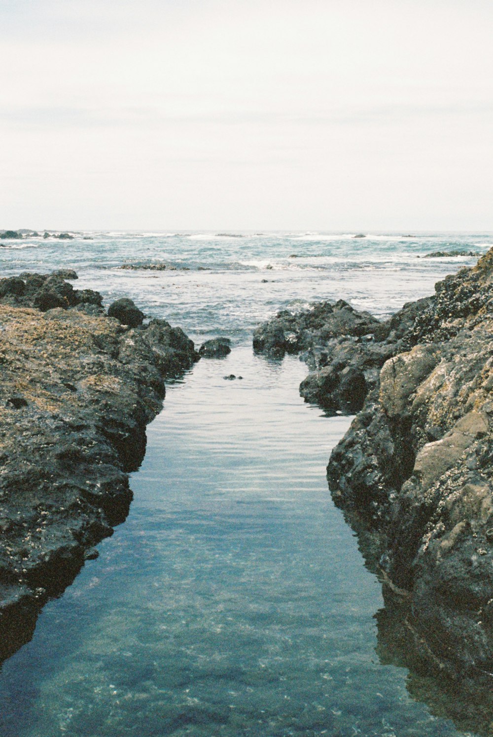 a body of water surrounded by large rocks