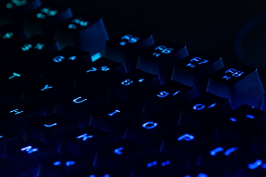 a close up of a blue illuminated keyboard