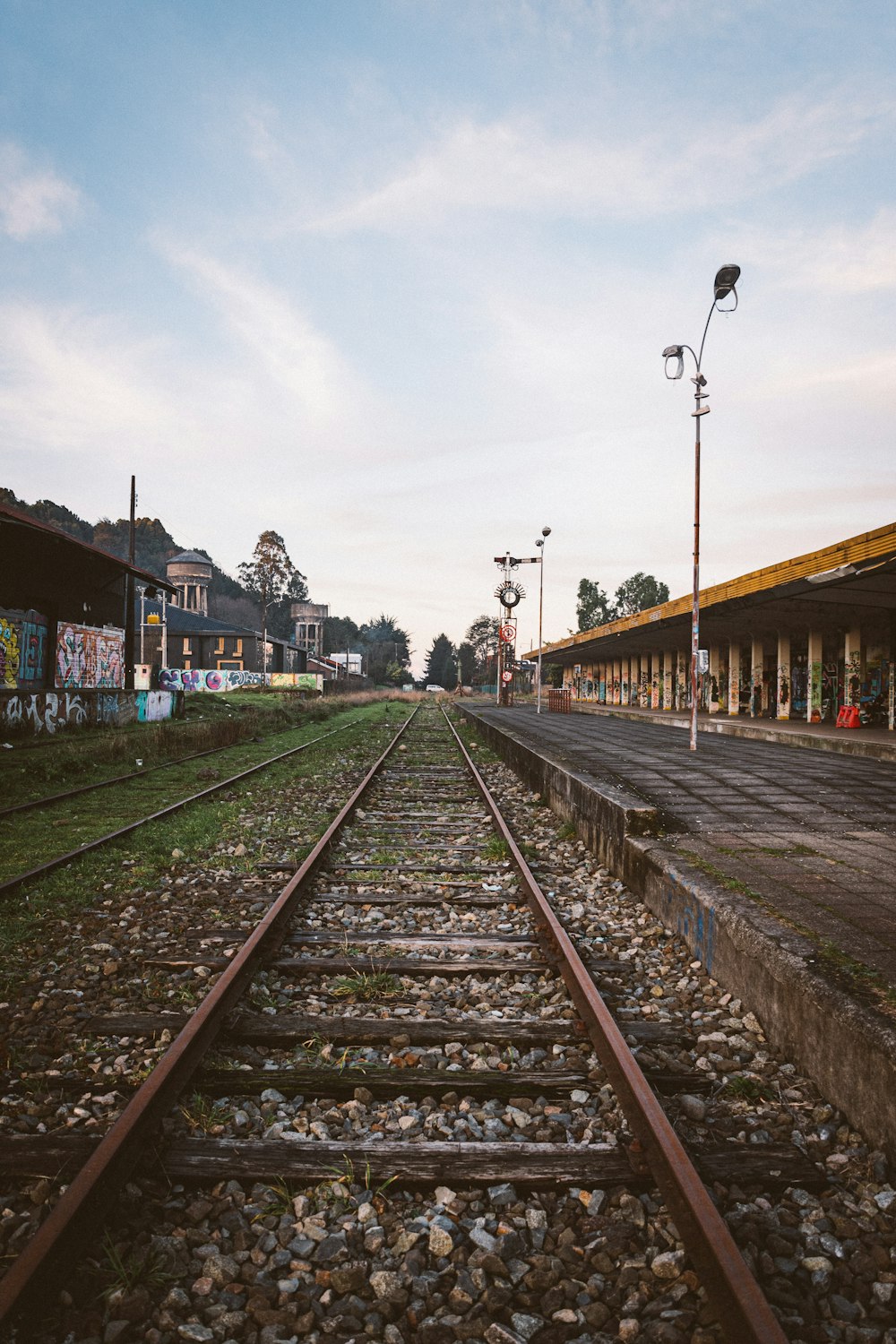 a train track with a building in the background