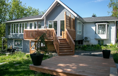 a house with a deck and stairs leading up to it