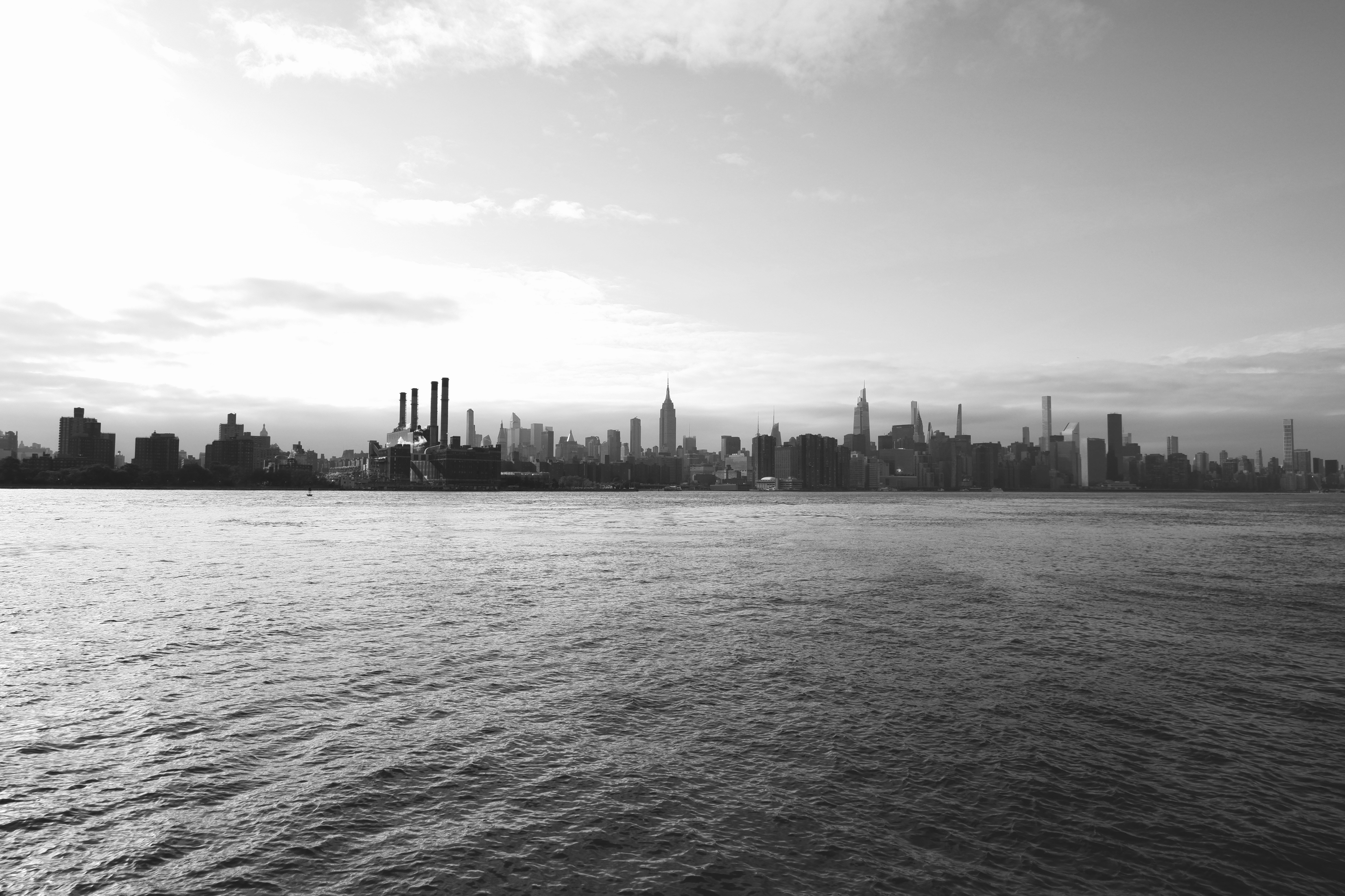 a large body of water with a city in the background