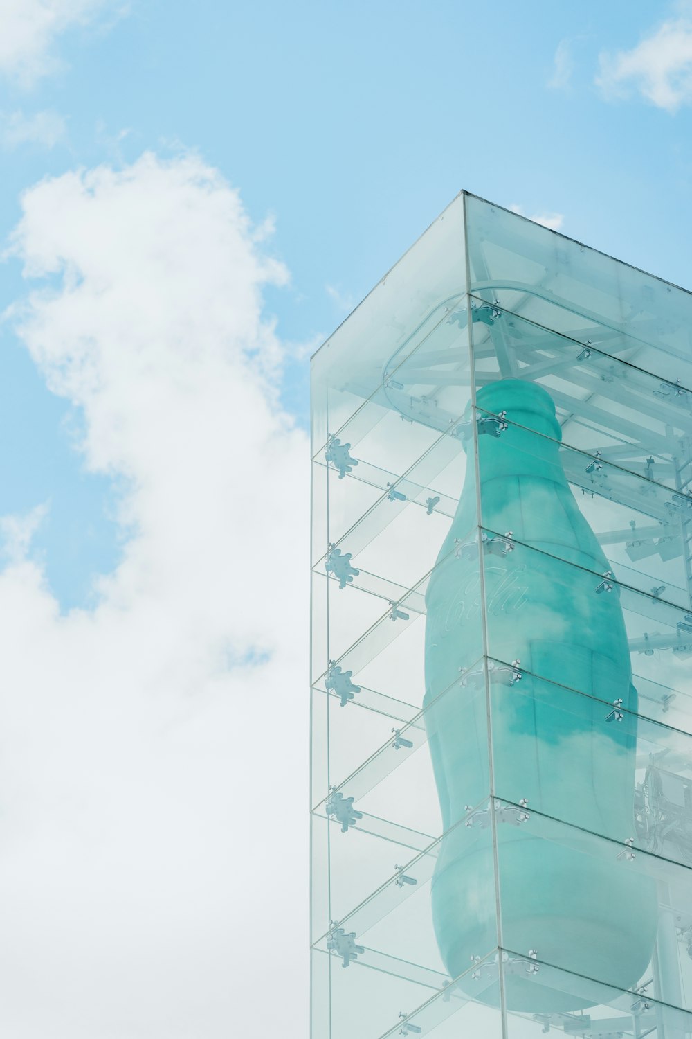 a large blue bottle sitting inside of a glass case