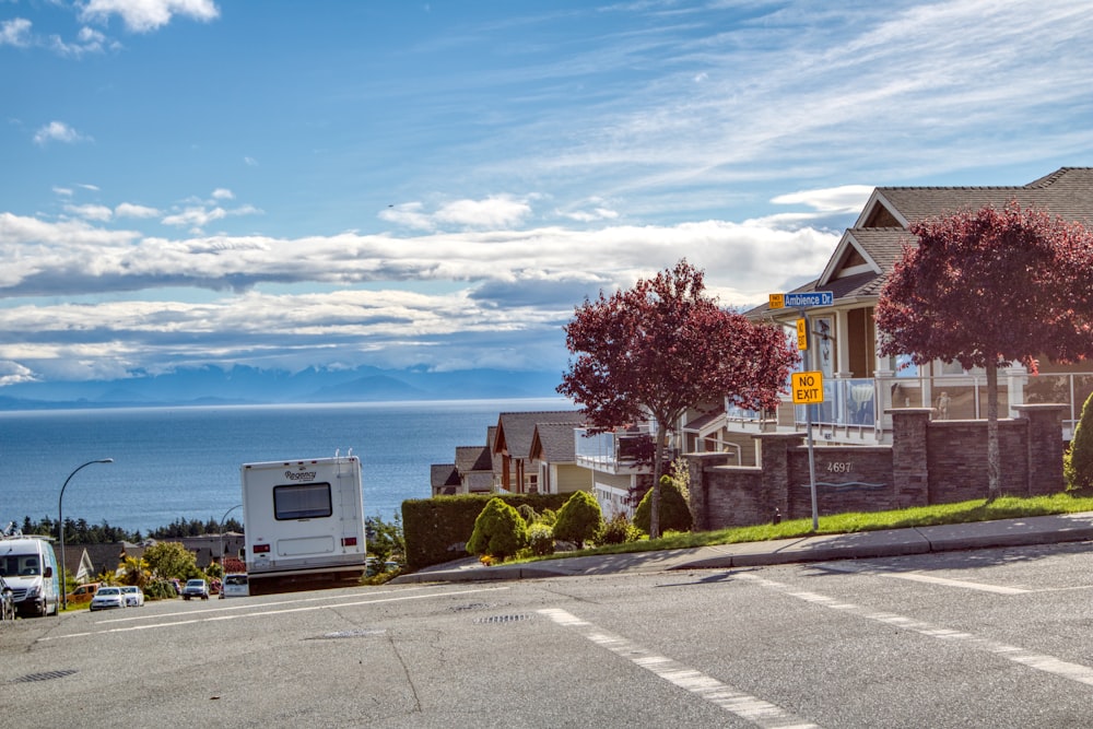 a view of a street with a car parked on the side of the road