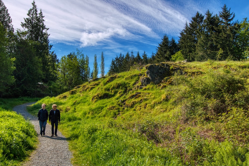 a couple of people that are walking down a path