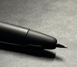 Hyperrealistic image of a soft touch pen with vibrant colors and clear studio lighting on a monochromatic background.