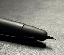 Close-up of premium metallic pens with tactile UV embossing on a clean white background.