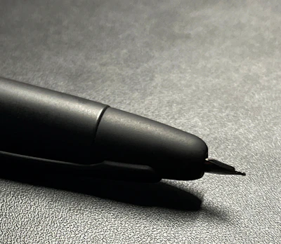 Close-up of premium metallic pens with tactile UV embossing on a clean white background.
