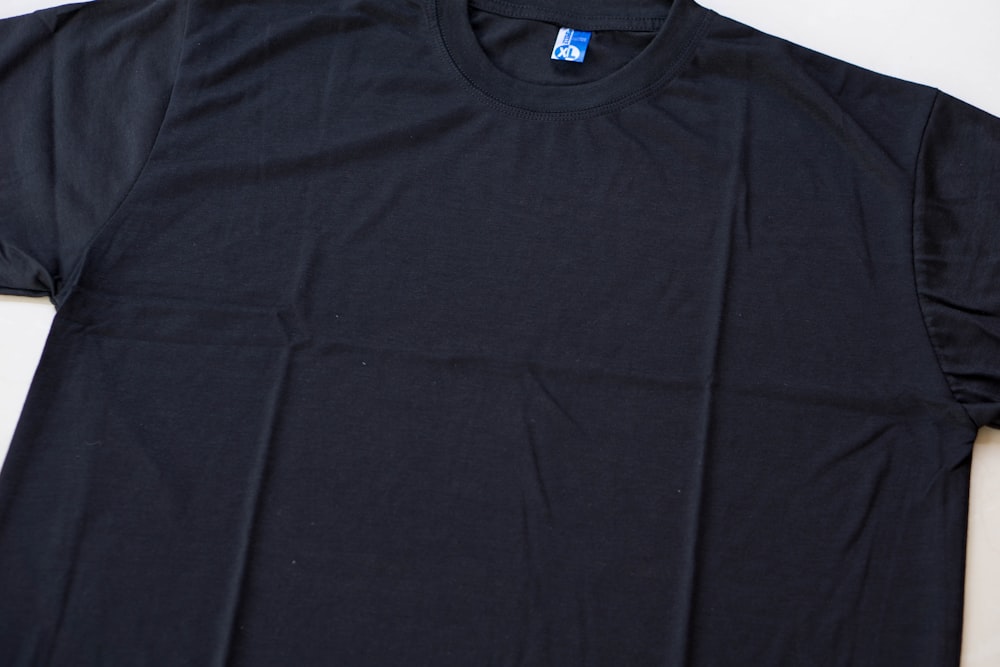 a black t - shirt with a blue logo on it