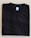 A neatly folded black T-shirt with a blue size label marked XL on a light-colored surface.