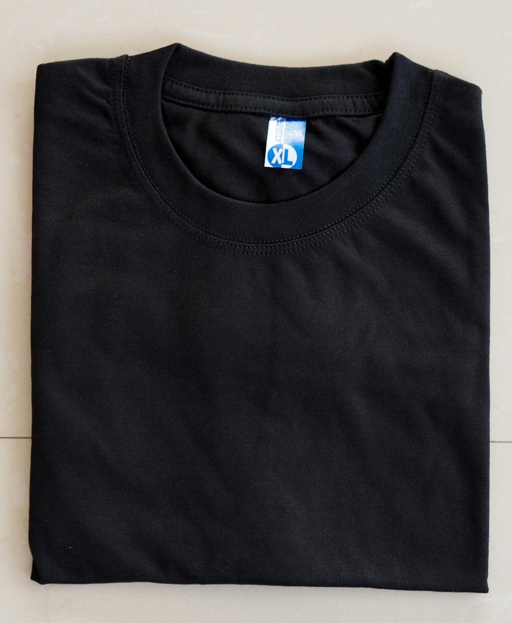 a black t - shirt with a blue logo on it