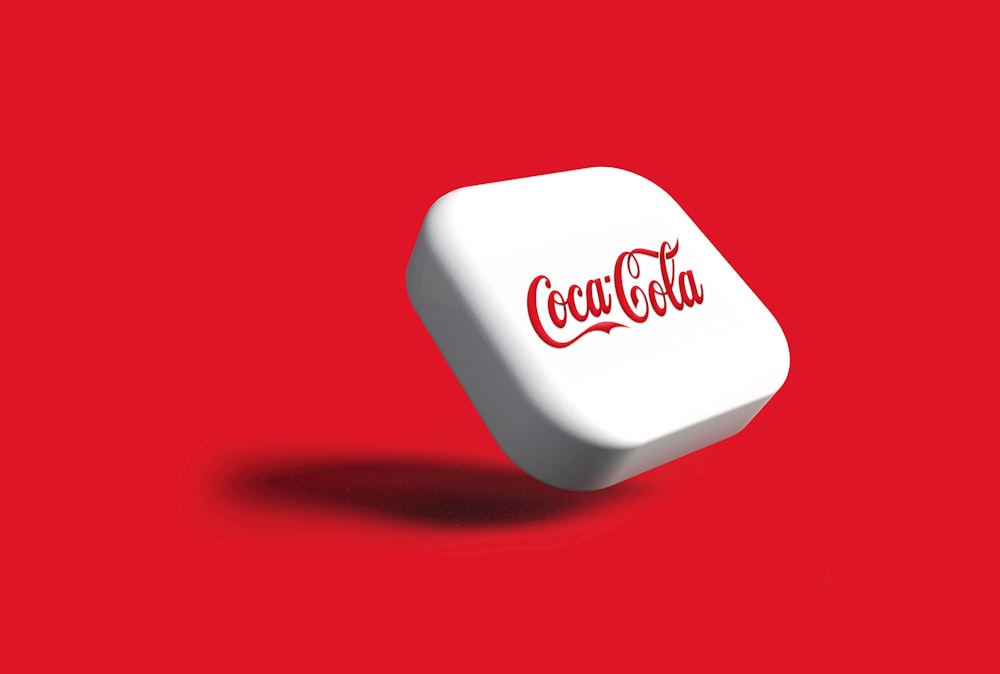 a white dice with the word coca cola on it