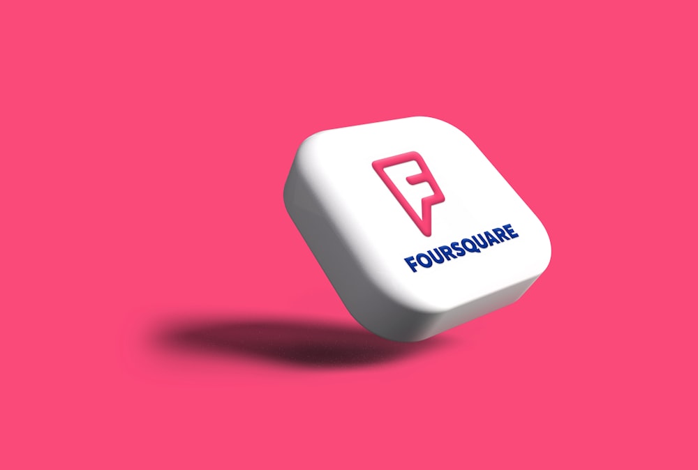 a white dice with the word foursquare on it