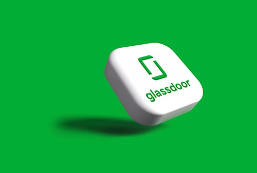 A 3D representation of the Glassdoor logo on a white square block against a green background.