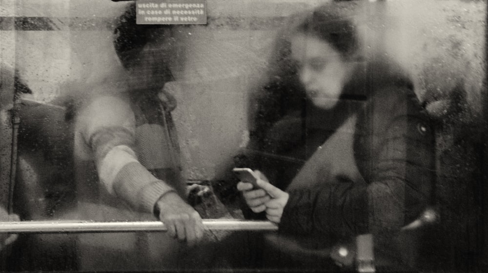 a man and a woman sitting next to each other on a train