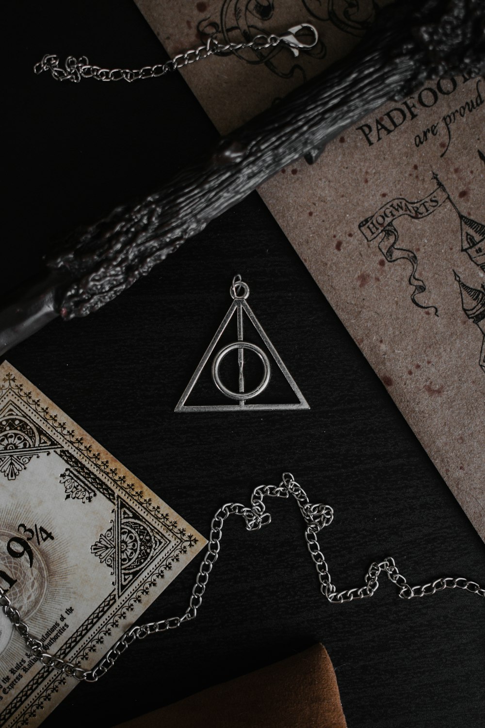 a harry potter necklace on a table