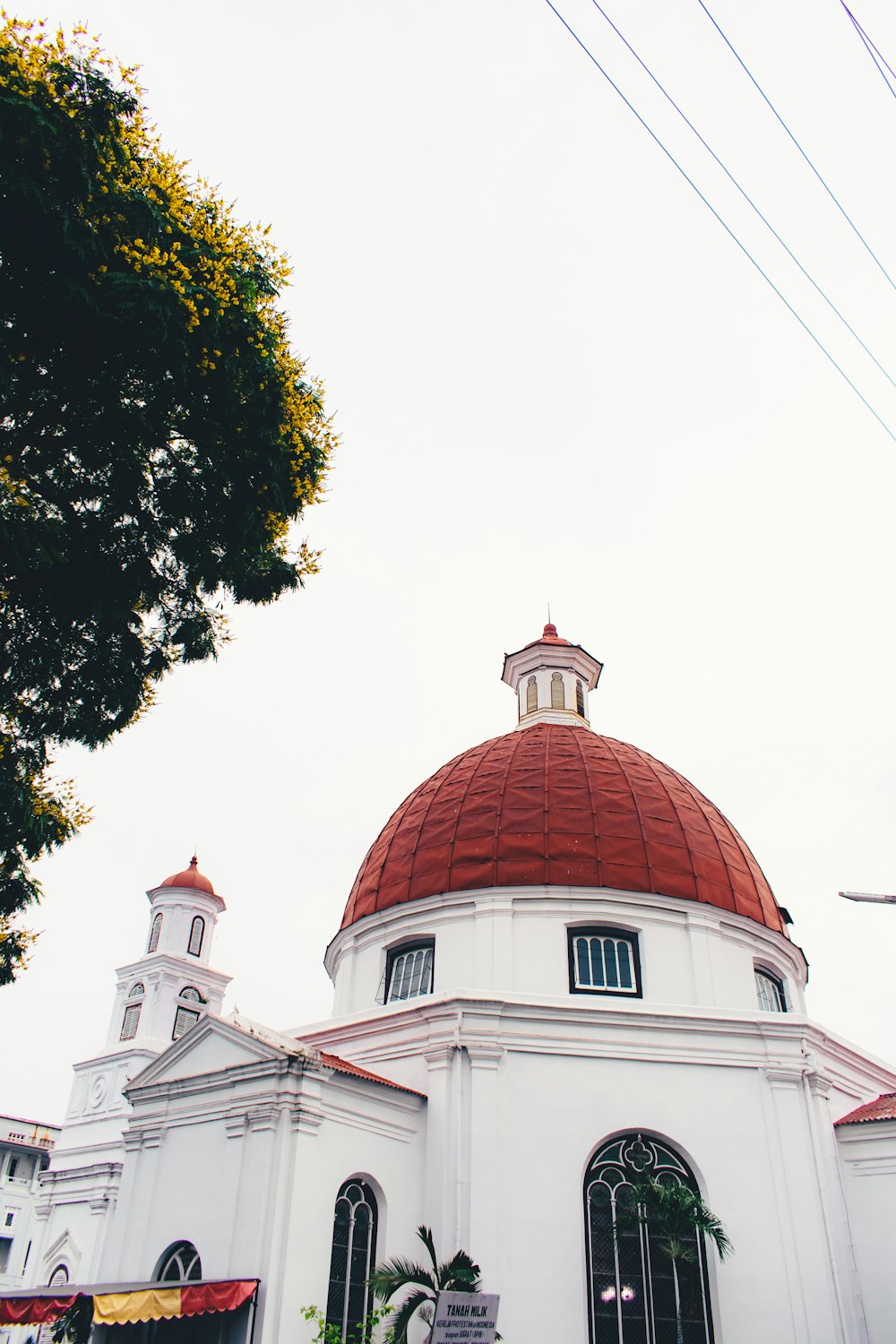 a large white building with a red dome