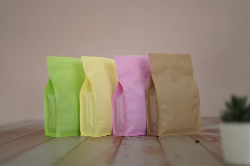 A neatly arranged set of oral pouches in minimalist packaging on an olive green surface