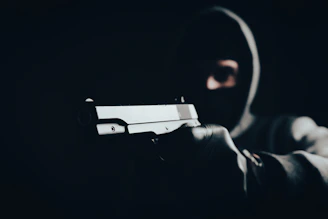 a man holding a gun in the dark