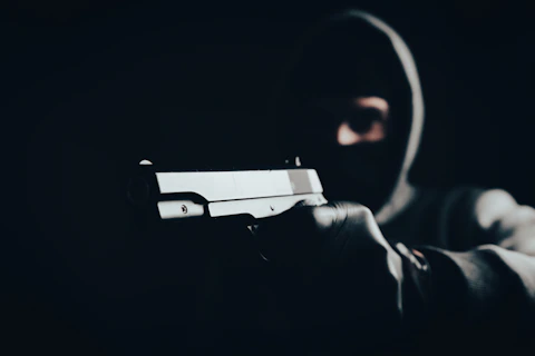 a man holding a gun in the dark