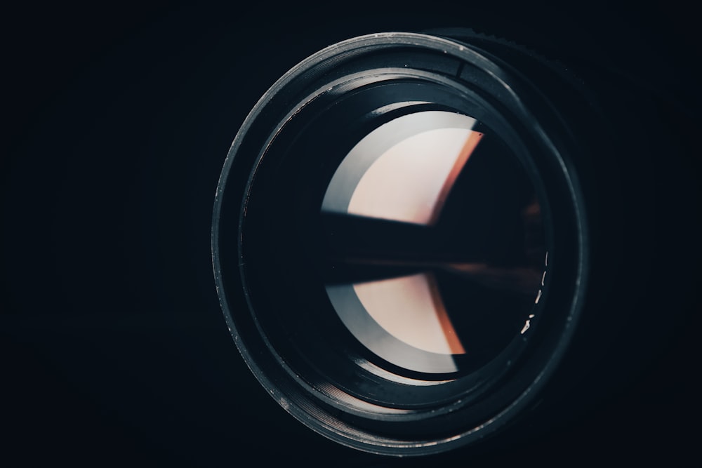 a close up of a camera lens in the dark