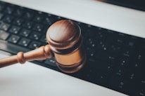 a wooden gaven sitting on top of a computer keyboard