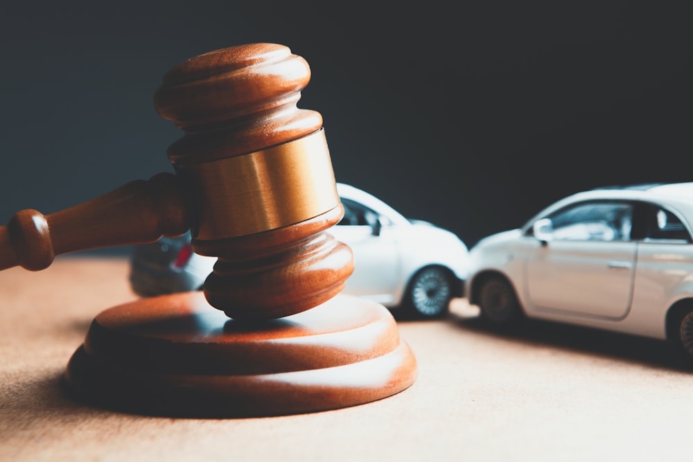 a toy car and a wooden gaven on a table