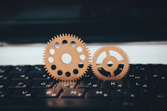 two wooden gears sitting on top of a keyboard