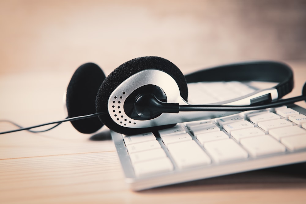 a pair of headphones sitting on top of a keyboard