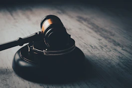 a judge's gaven on a wooden table